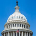 A striking image of the US Capitol dome with clear blue sky, showcasing American architecture and history.